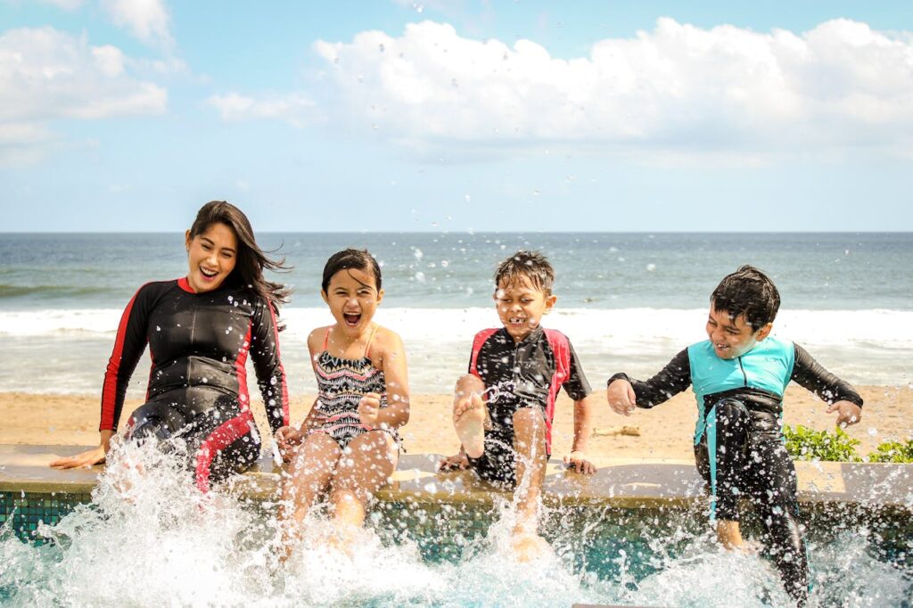 pexels-photo-1231365 A family having fun splashing water near the seashore on a sunny day in Bali, Indonesia.